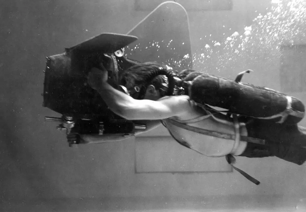 U.S. Navy Photographer-Diver swimming & shooting with a Éclair Aquaflex underwater motion picture camera.